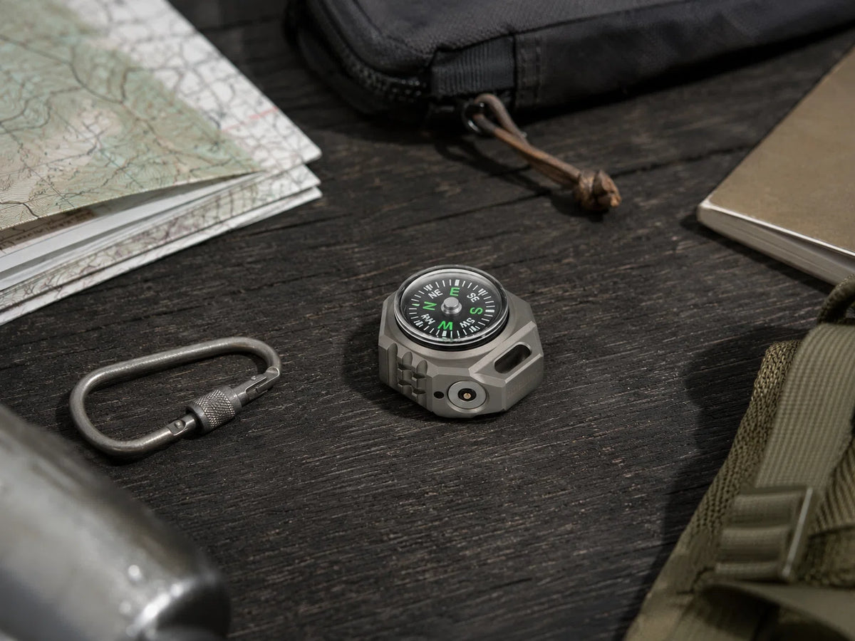 FIELDLUME T9 with built-in compass alongside outdoor navigation gear