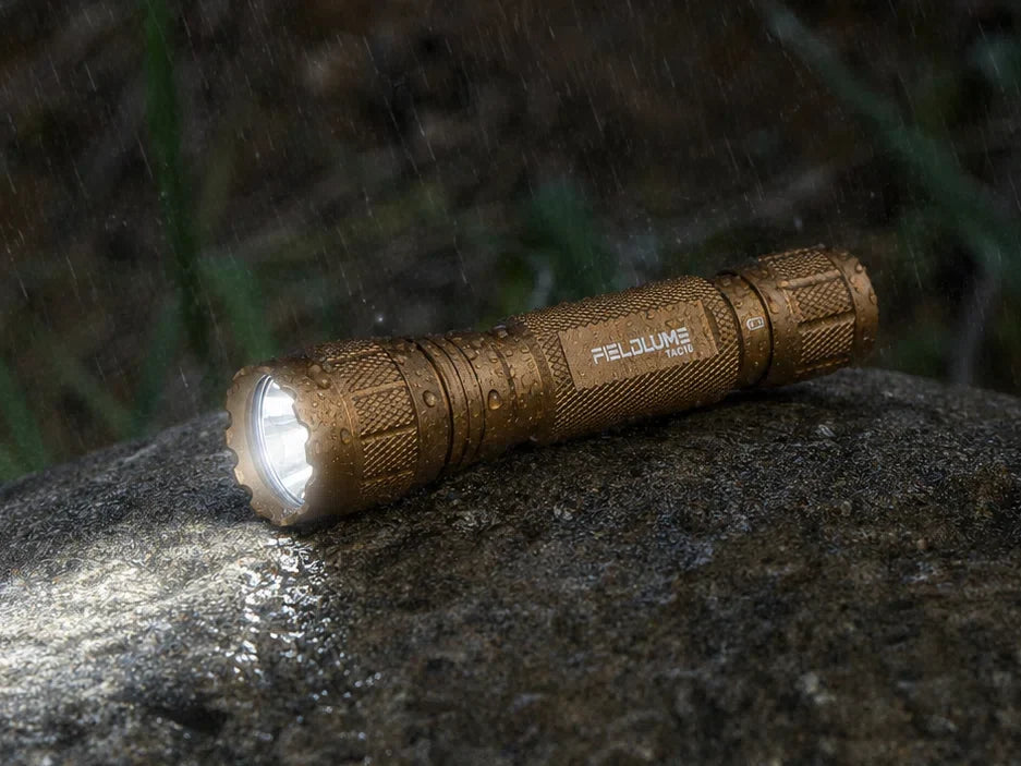Outdoor	FIELDLUME TAC10 tan flashlight on wet rock in rain
