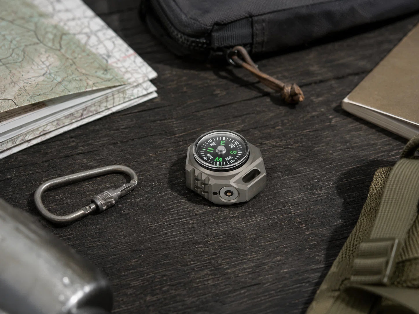 FIELDLUME T9 with built-in compass alongside outdoor navigation gear