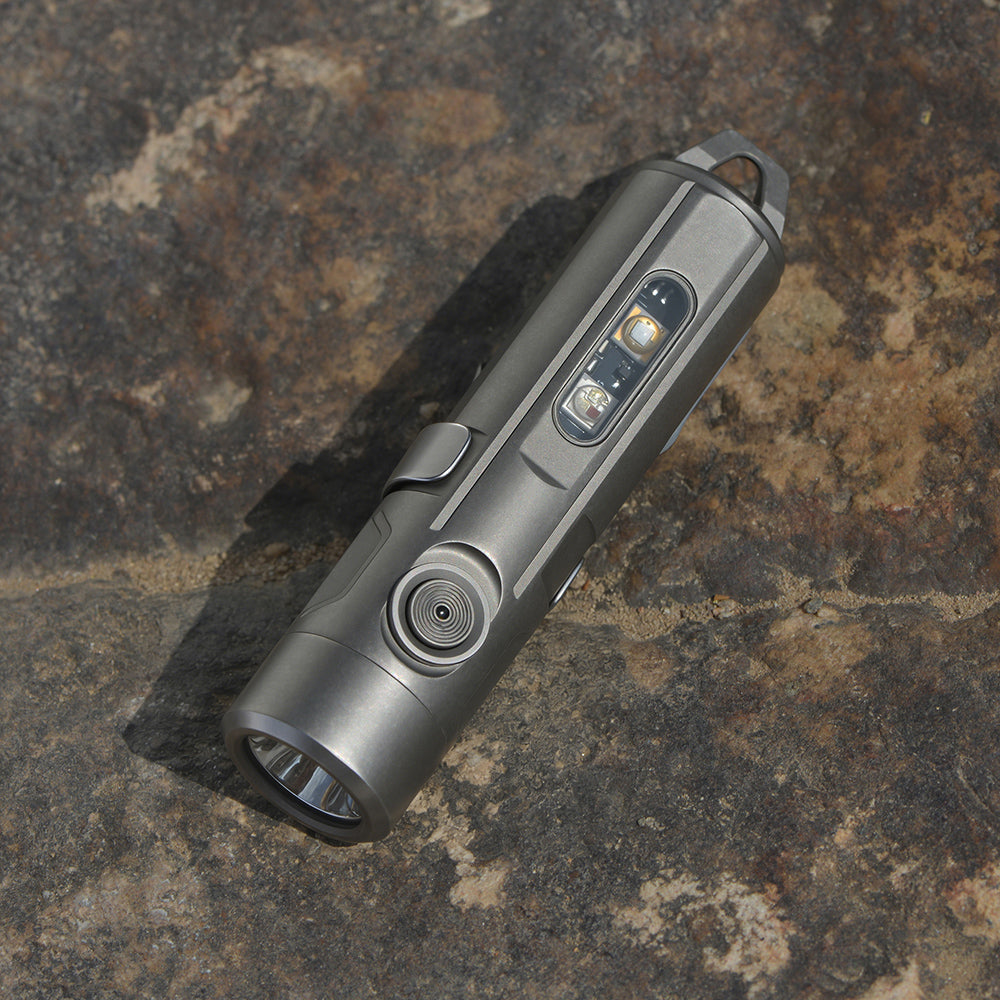 Silver flashlight on a textured stone surface