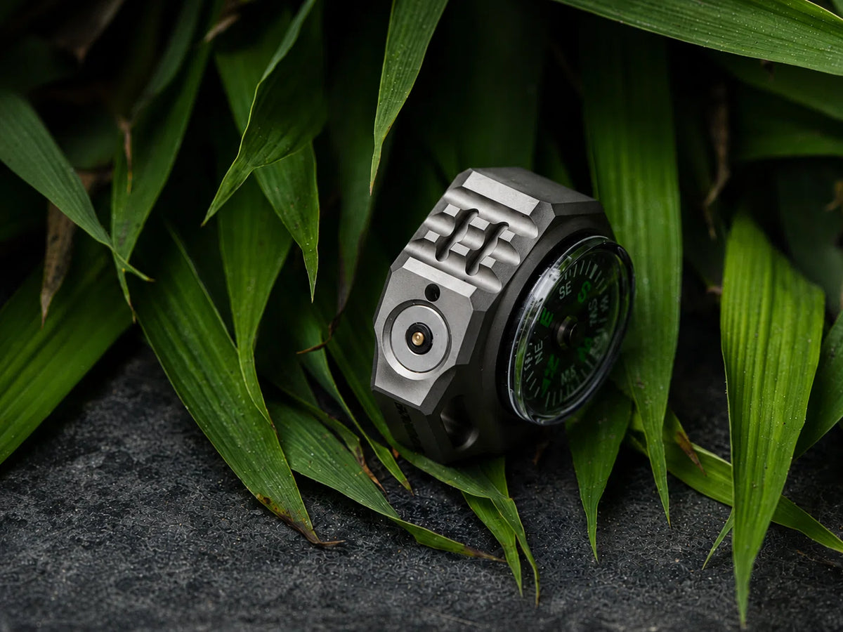 FIELDLUME T9 titanium EDC torch showing magnetic charging contact