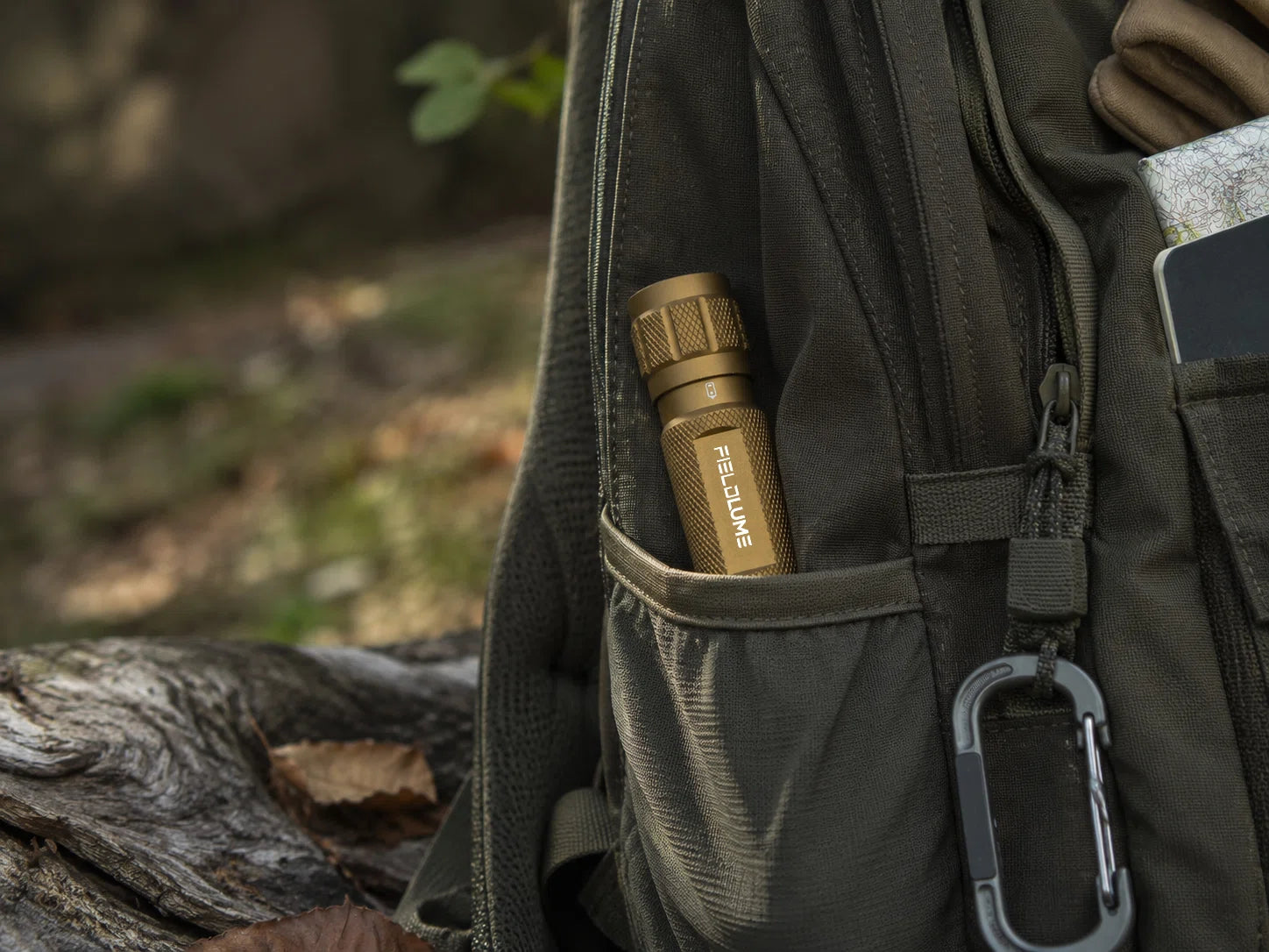 EDC	FIELDLUME TAC10 tan flashlight carried in an outdoor backpack pocket