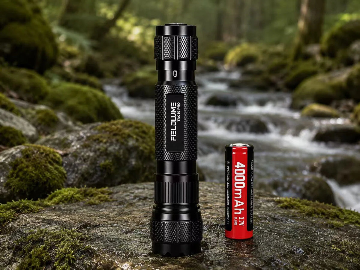 FIELDLUME TAC10-Pro Blood Tracking Light with 18650 4000mAh battery beside a mossy creek